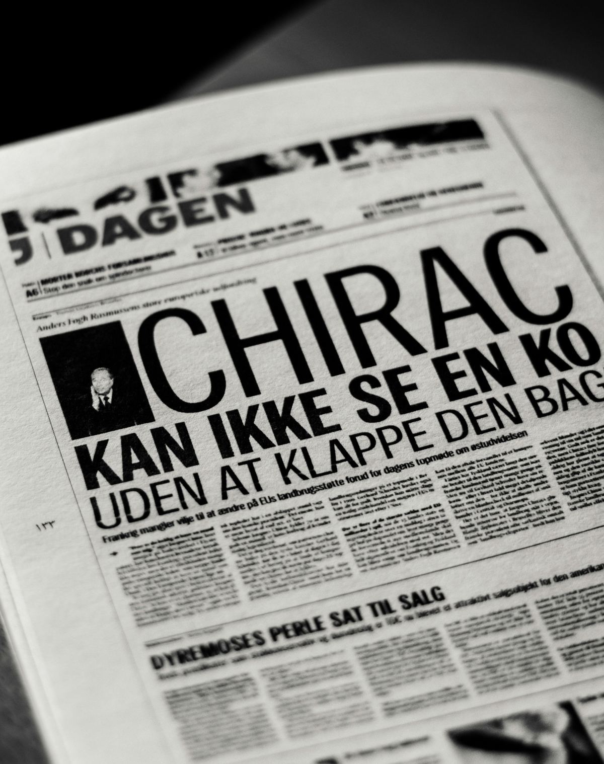 A close-up of a printed newspaper with bold editorial typography